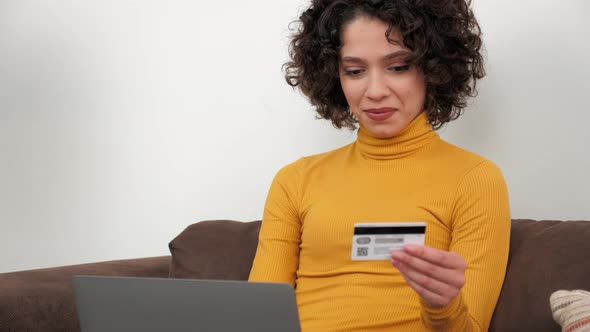 Woman Customer Enters Credit Card Code to Pay Gifts Online Shopping Via Laptop
