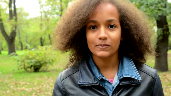 Young Beautiful Satisfied African Girl Walks in the Forest and Stare in To Camera - Detail of Face