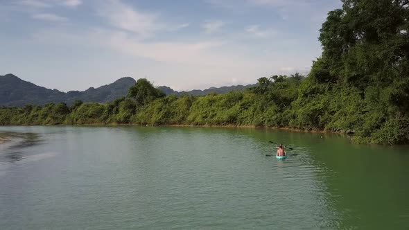 Upper Backside Couple in Canoe Sails To Forestry River Bank