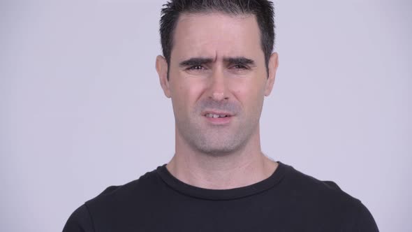Face of Stressed Man Looking Frustrated and Bored Against White Background