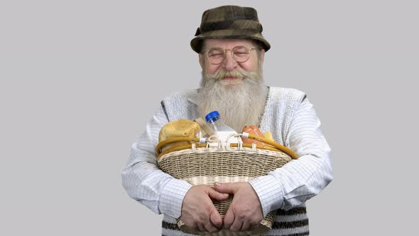 Portrait of Happy Grandpa with Straw Basket of Food