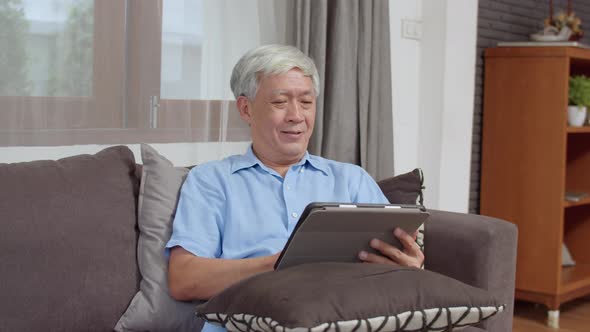 Asian Senior Chinese male search information about how to good health on internet while lying.