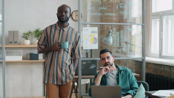 Portrait of Two Multiethnic Male Colleagues in Office