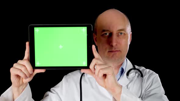 Male Doctor in Medical Gown with Stethoscope Holding Tablet Pc with Chromakey Screen