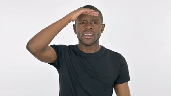 Young African Man Looking Around Searching on White Background