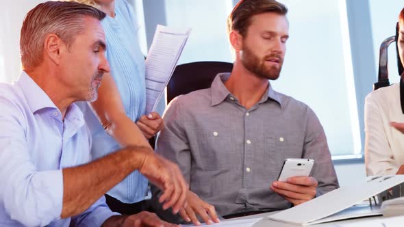 Executives shaking hands while working