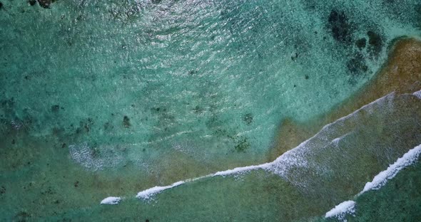 Tropical fly over copy space shot of a sandy white paradise beach and blue water background