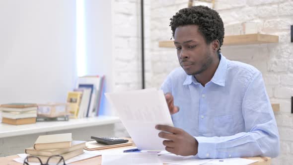 African Man Reading The Documents