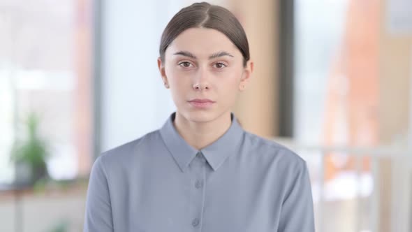 Portrait of Young Latin Woman Looking at Camera