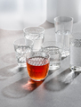 Glasses with water and a drink on a gray stone table. Shooting w - PhotoDune Item for Sale