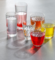 Colored soft drinks in glass faceted glasses on a gray table. Ph - PhotoDune Item for Sale