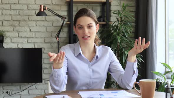 Happy beautiful woman blogger looking talking to camera. Pretty girl recording vlog at home, smiling