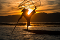 Burmese fisherman posing with conical net at sunset, Inle Lake i - PhotoDune Item for Sale
