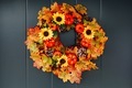 Autumn wreath with sunflowers, pumpkins and maple leaves on front door - PhotoDune Item for Sale