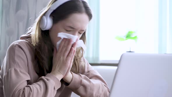 Young Woman Having a Flu and Sneezing