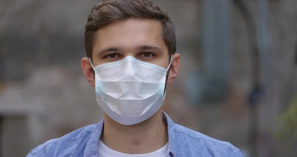 Portrait of Cheerful Man Take Off Medical Mask and Smiling Looking at the Camera