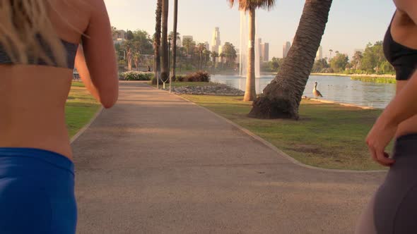 Athletic Twins Running In The Park Slow-Motion