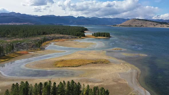 Aerial view flying over the marsh at Hebgen Lake along the shoreline