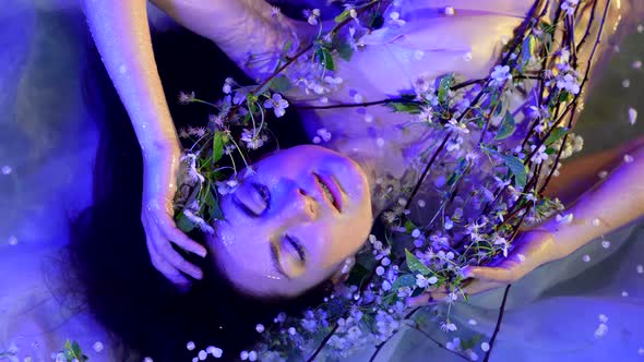 Amazing Portrait of Woman with Flowers in Water of Shallow Lake or River in Night