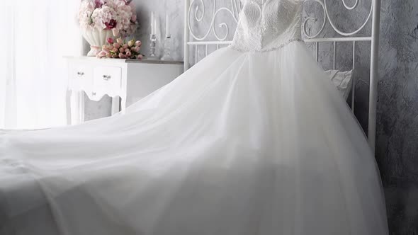 Slow Motion White Wedding Dress on Bed Near Nightstand