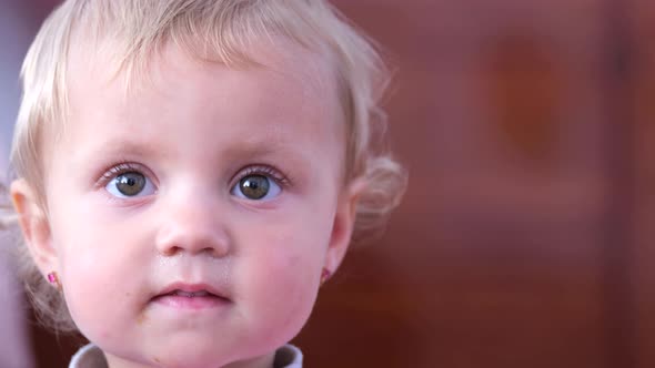 Portrait of a Cute Little Girl with Blue Eyes