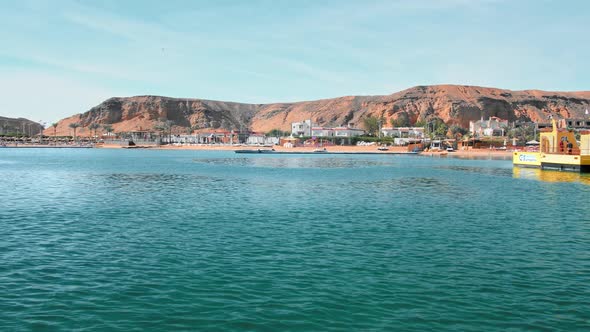 Tropical Landscape Blue, Turquoise Sea, Against the Yellow Coast of Desert Mountains