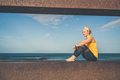 Yoga girl meditating and relaxing in yoga pose, ocean view - PhotoDune Item for Sale