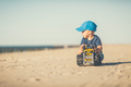 Toddler boy playing on a sunny beach - PhotoDune Item for Sale
