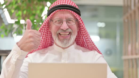 Old Arab Businessman with Laptop Showing Thumbs Up 