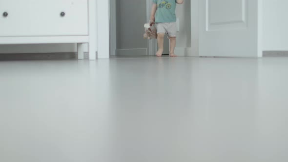 First Steps Closeup View Toddler Baby Legs and Feet Barefoot Walking on Floor