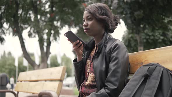 Handsome Trendy African American Black Woman Recording Voice Message on Cell Phone That He Is