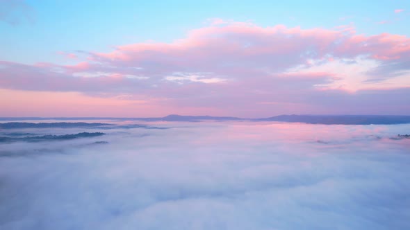 4K Aerial video Beautiful sunrise above dense clouds and fog in the morning