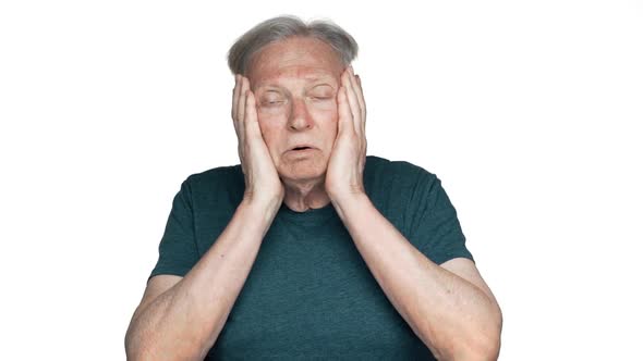 Portrait of Elderly Confused Man Grabbing His Head in Panic and Being Stressed or Nervous in Slow