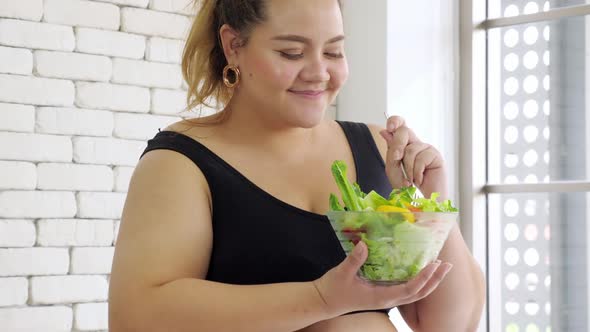 Happy overweight woman enjoy eating healthy food