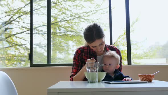 Mother feeding breakfast to her baby 4k