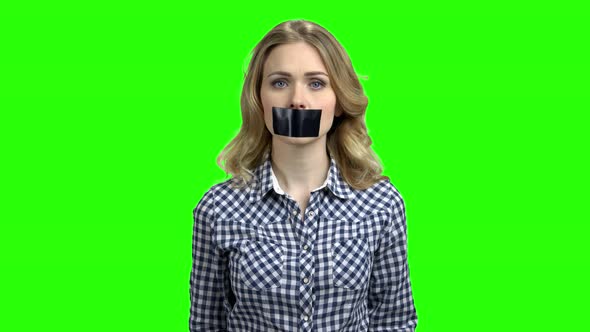 Young Woman with Black Tape Over Mouth