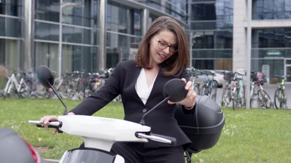 Trendy Formal Woman in Suit Sitting on Motorbike