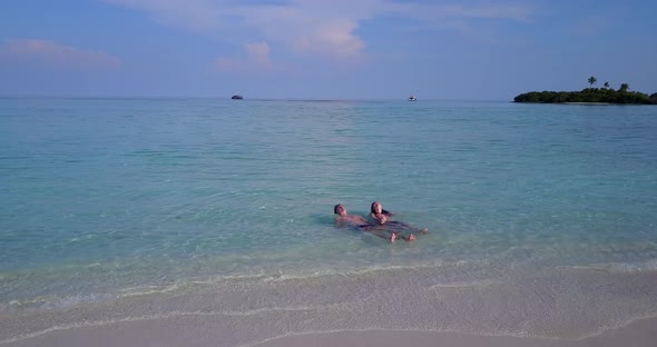 Happy boy and girl on romantic honeymoon live the dream on beach on paradise white sand 4K background