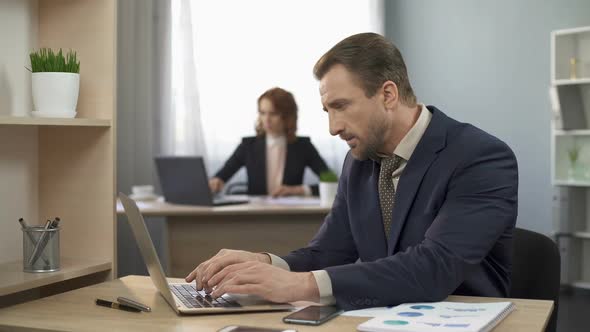 Office Manager Typing Data on Laptop, Finishing Project, Satisfied With Results