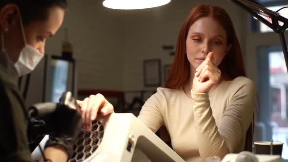 Closeup Tracking Shot of Happy Pretty Young Woman Client Examining Treated Nails and Assessing Work