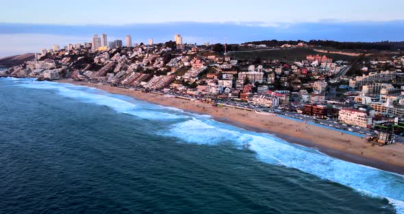 Panoramic aerial view of Reñaca at sunset with its buildings and the coastline of its beach.