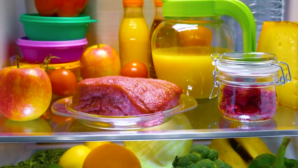 Fresh Raw Meat on a Shelf Open Refrigerator