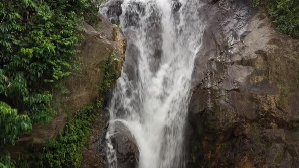 Crane shoot moving up focusing on a waterfall