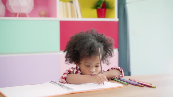 African kids drawing and do homework in classroom, young girl happy funny study and play painting.