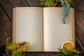 An open old book with blank pages and floral decor on an old woo - PhotoDune Item for Sale