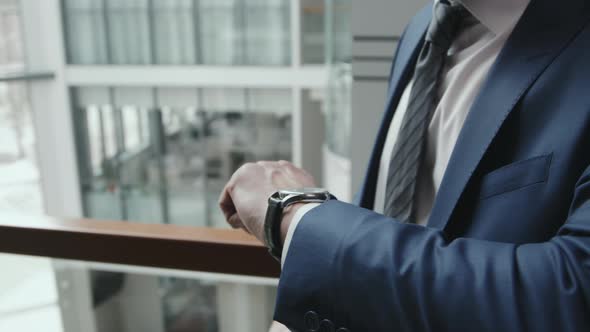 Business Man in Suit Looking at Wrist Watch