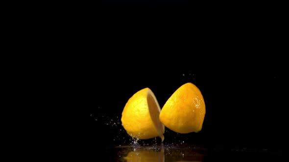 Super Slow Motion Juicy Lemon Falls on the Table and Breaks Into Halves