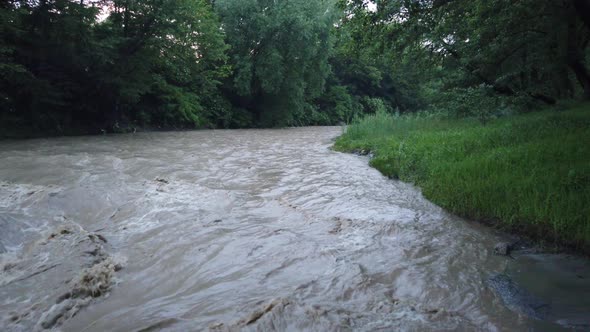 River flowing after heavy rain. Water stream After strong rain. Dirty and turbulent water after rain