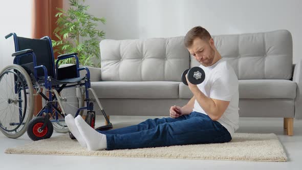 Disabled Athlete Performs Exercises with Dumbbells on Wheelchair Background