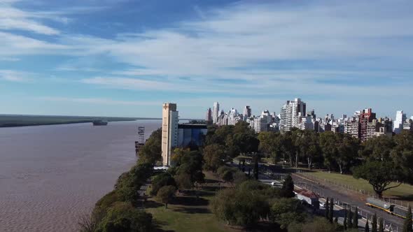 circular and downward flight on the banks of the parana river with the city of Rosario in argentina